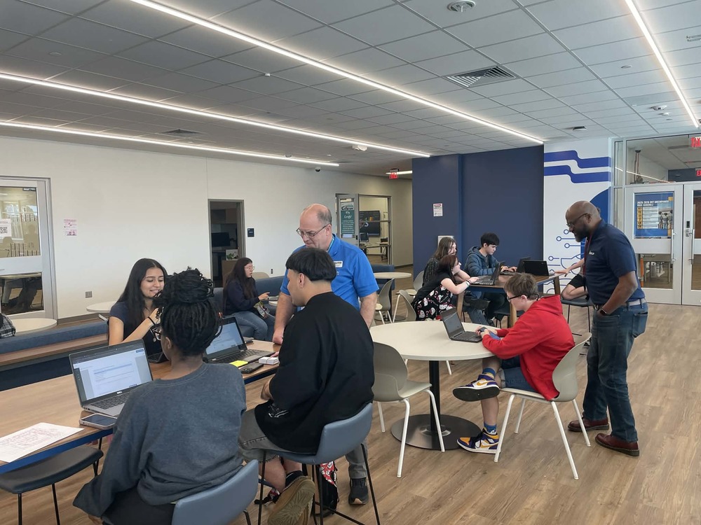 Students sit in the flex space area of Huntsville Center for Technology while receiving assistance from adults on the FAFSA