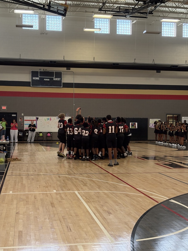The WMS football team circled together after being announced at the pep rally.