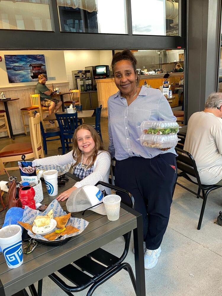 PES teacher and student enjoying food