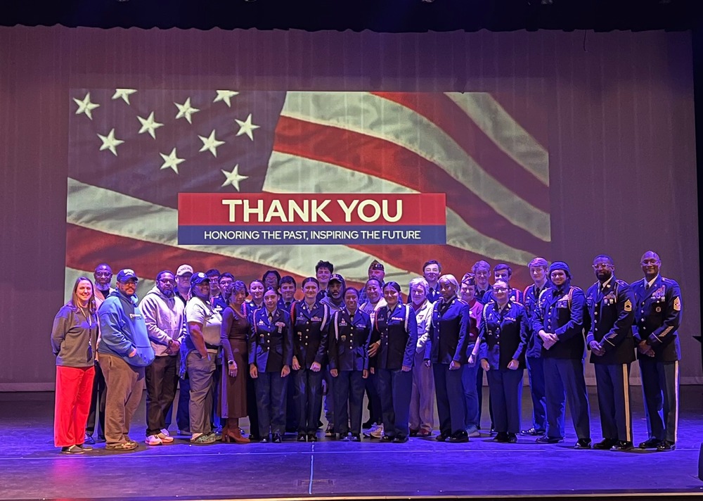 JROTC pose with veterans at the Veteran's Day program.