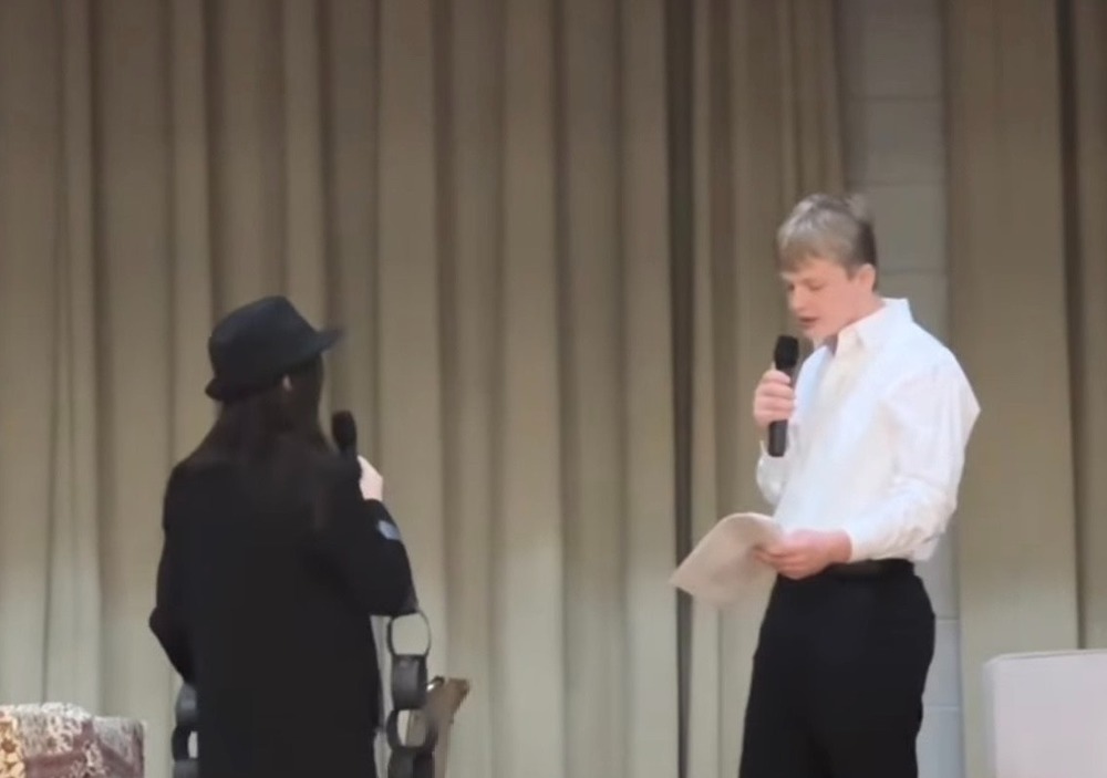 Two students on stage performing A Christmas Carol