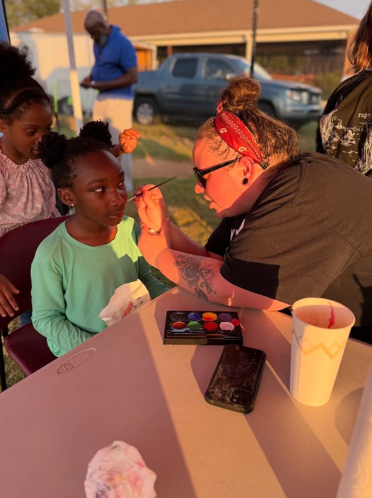 Mrs. Henderson face painting at the Columbia High School homecoming tailgate. 