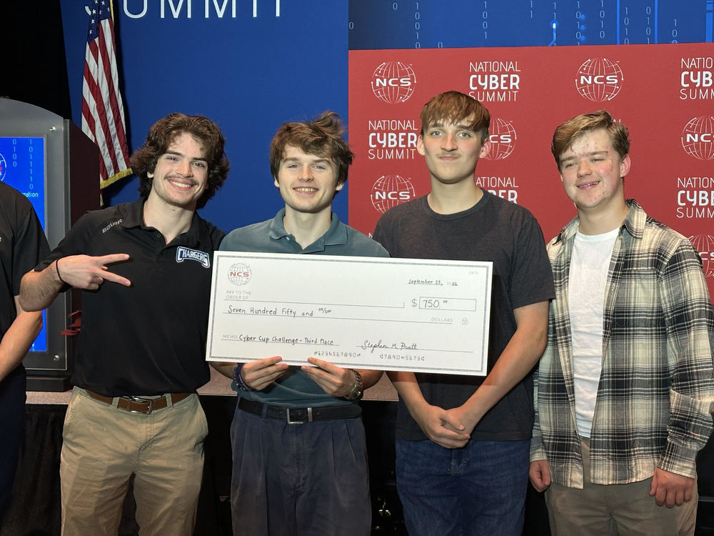Cyber Patriot students pose with a check for the third place prize they recently won.