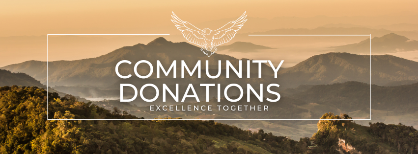 Beige and green mountains in the distance. There is a white rectangle with an eagle at the top enter and the words "Community Donations" and "excellence together" in the center. 