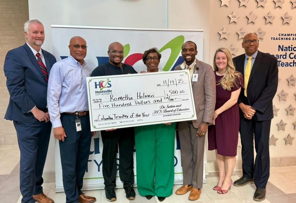 Pictured are district people with Teacher of the Year holding $500 check