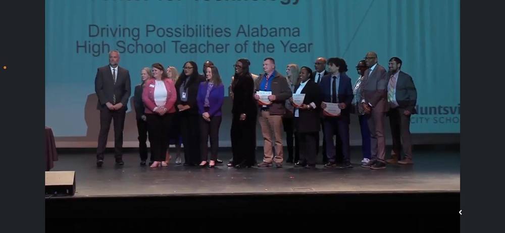 Educators stand on a stage holding certificates during the Huntsville City Schools 2026 Galaxy Awards Night.