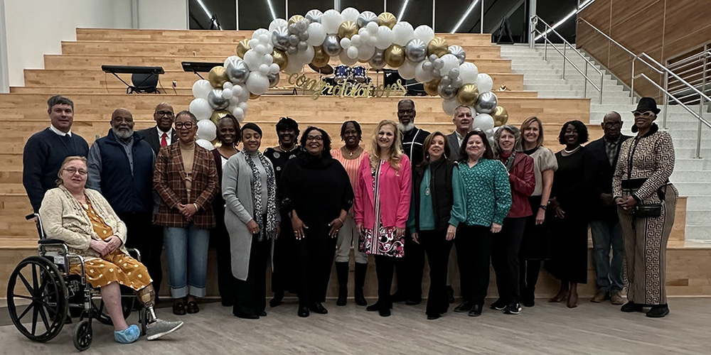2025 Retirees pose on the steps at HCT for the retirement celebration