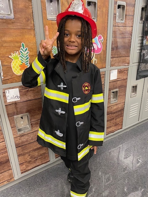 Christian McClendon wearing a Firefighter Outfit.