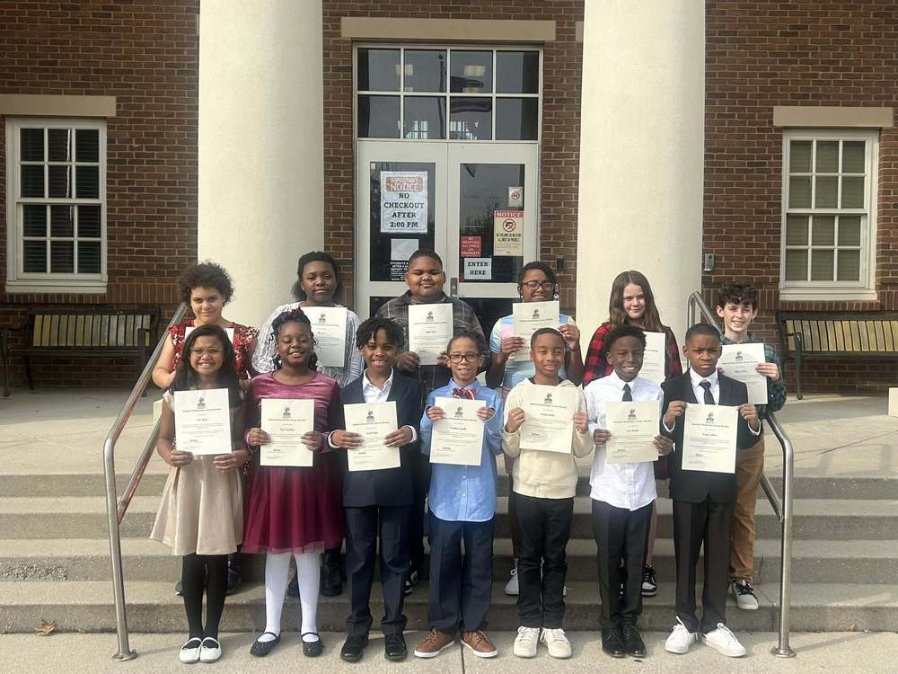 PES National Elementary Honor Society Holding their certificate.