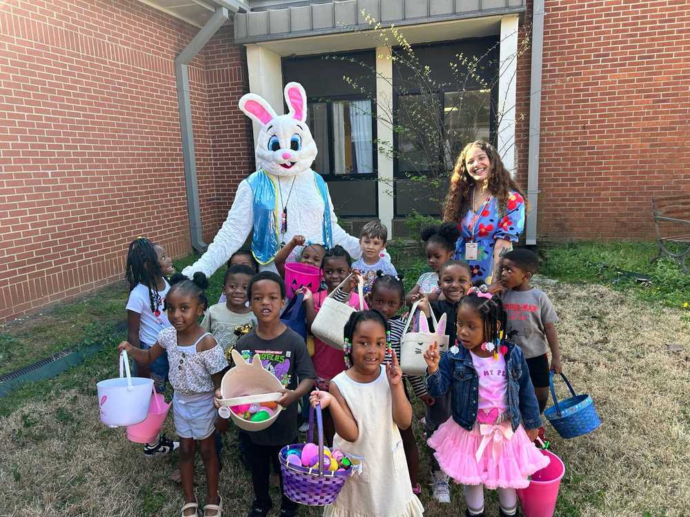 RHES students stand outside  with a teacher and the Easter Bunny 