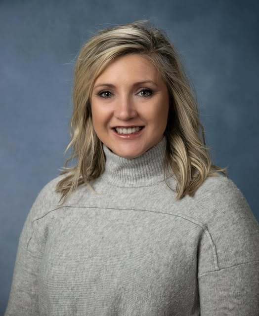 Mrs. Freeman in front of a blue background