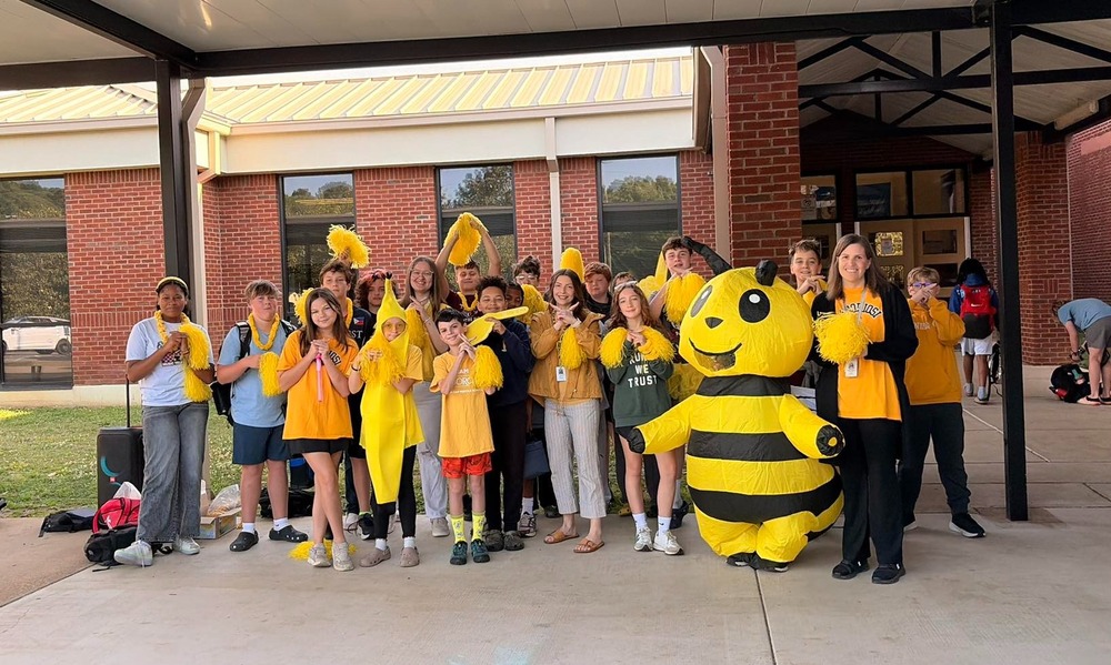 Group picture of yellow house team members welcoming students into school on Wednesday morning