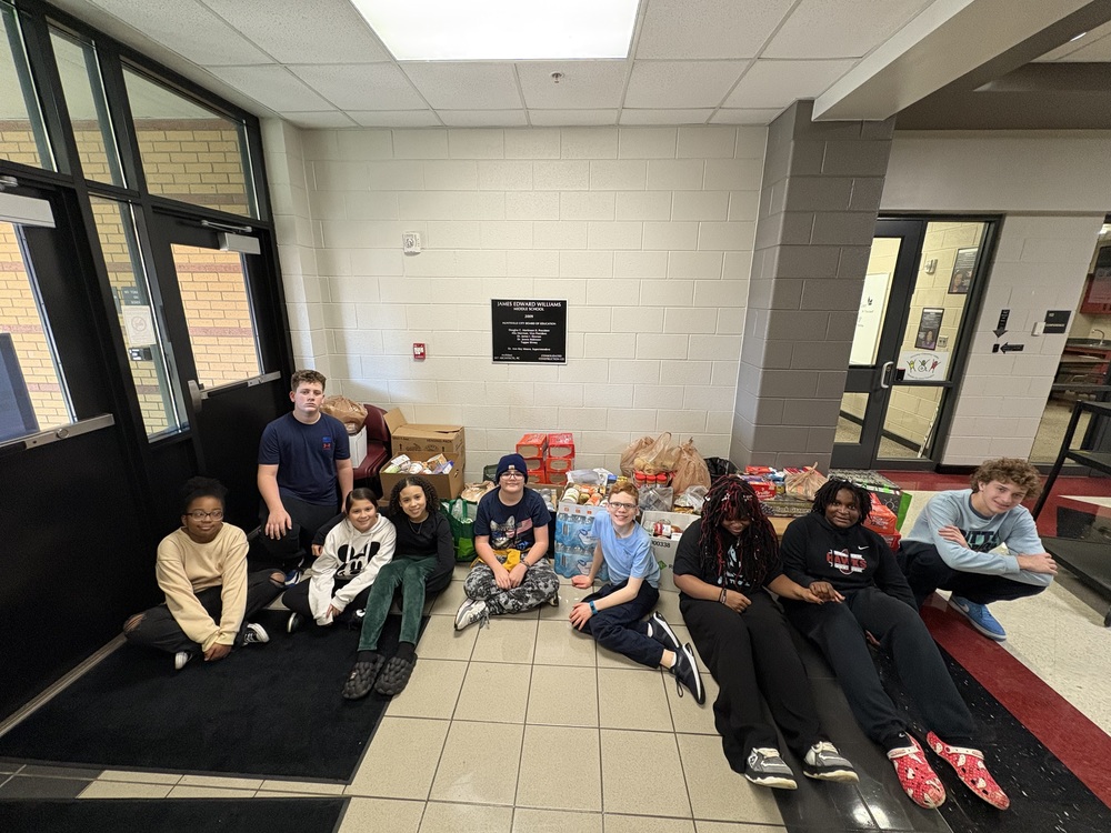 SGA members and top donors in front off all the food collected for the Rose of Sharon food drive.