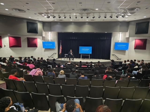 Mr. Hilinski speaking to the 8th graders in the auditorium. 