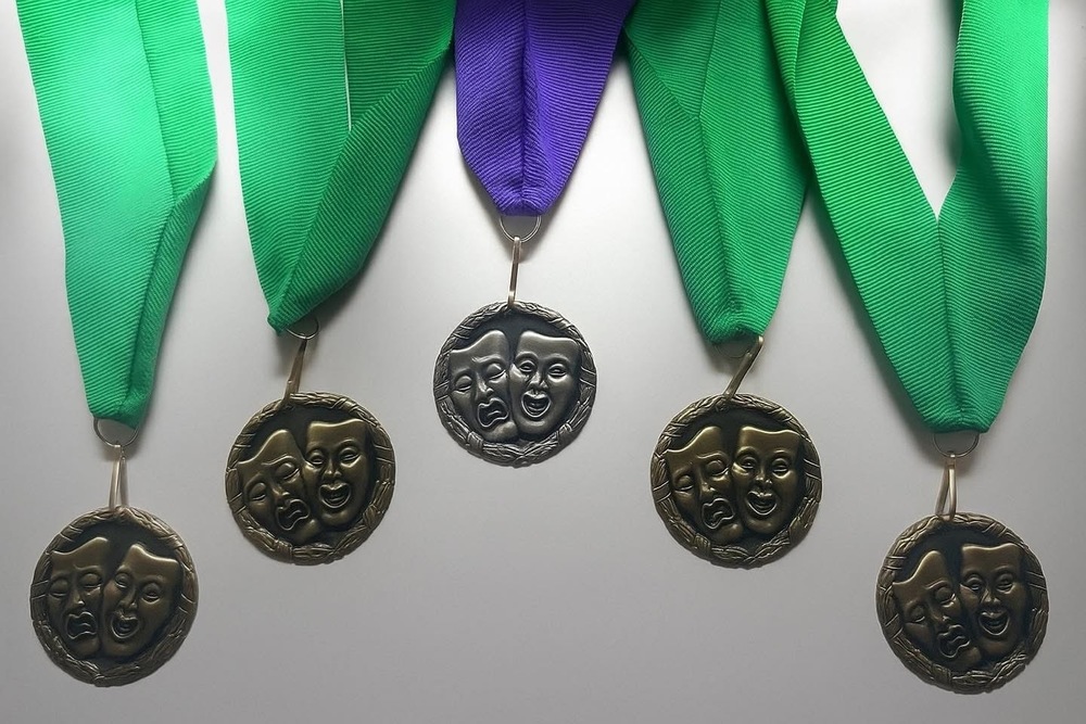 5 theater medals with 2 green ones on the end and and a purple medal in the middle