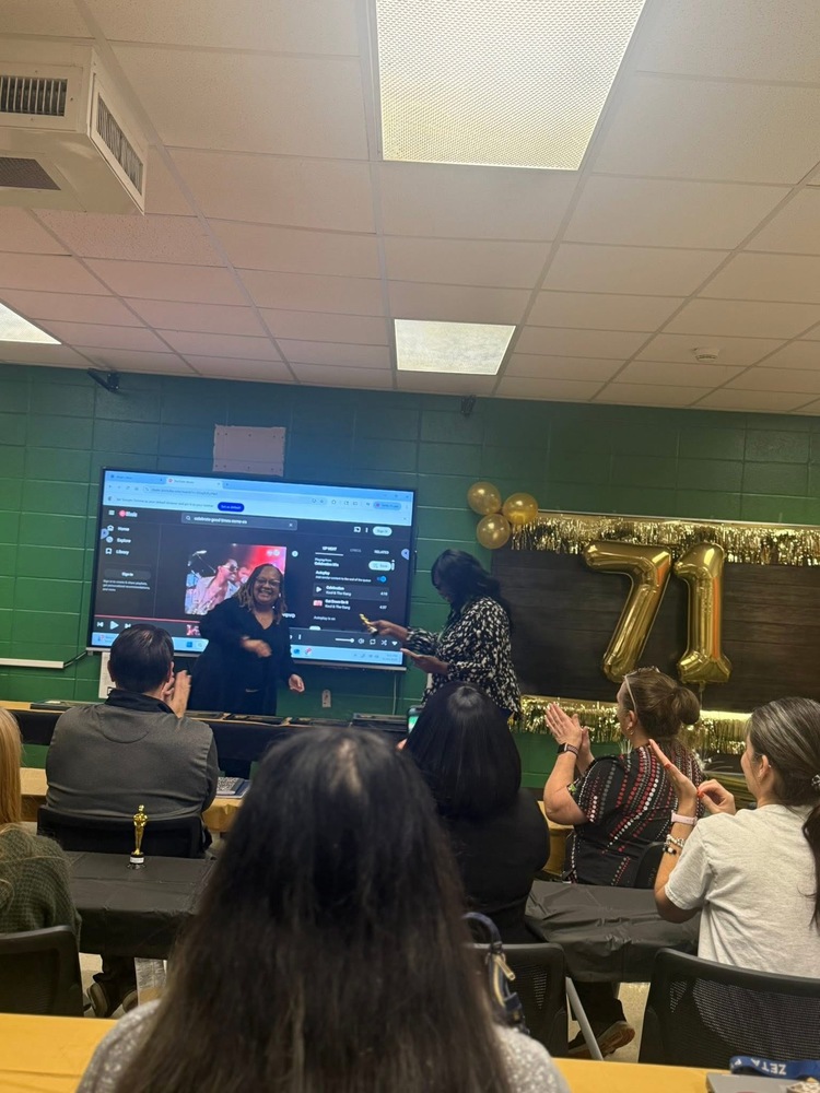 Mrs. Askew(black dress) and Ms. Scott(black and white top) at the front along with some staff. They are passing our certificates and trophies to teachers in the testing grades- 2nd-5th grade