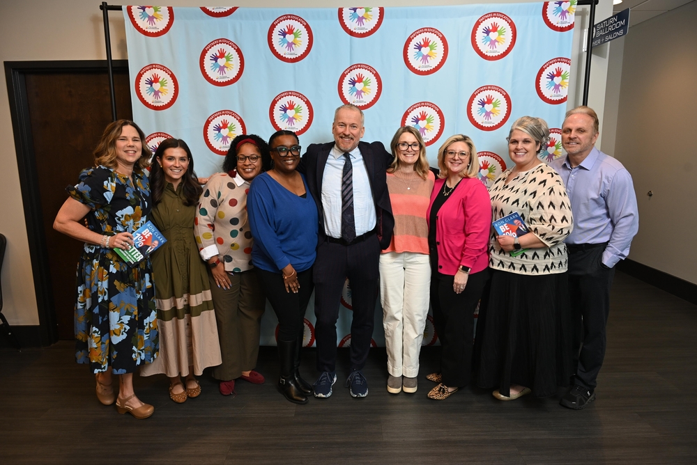 Chaffee staff standing together  with Ron Clark in front of a banner at the VBC