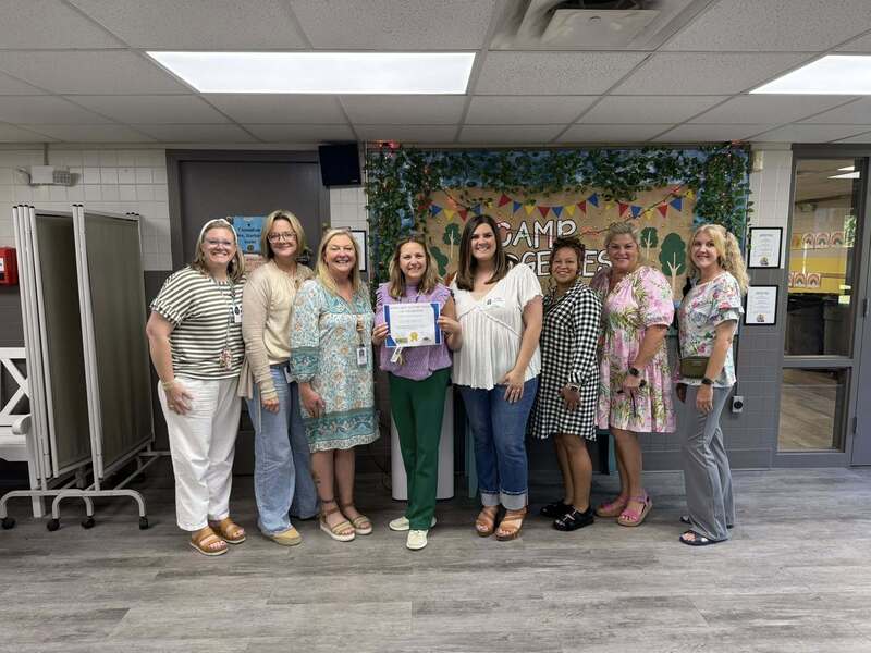 Nurse Sherry receiving her award from community partners and administration.