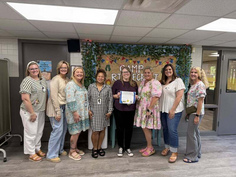 Ms. Wade-Beebe accepting her award from community partners and administration.