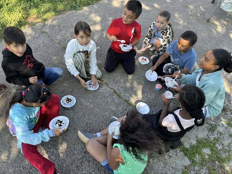 First graders enjoying their ice cream sundaes.