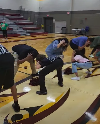 Teachers line up against students for a competition involving sharp hearing and speed.