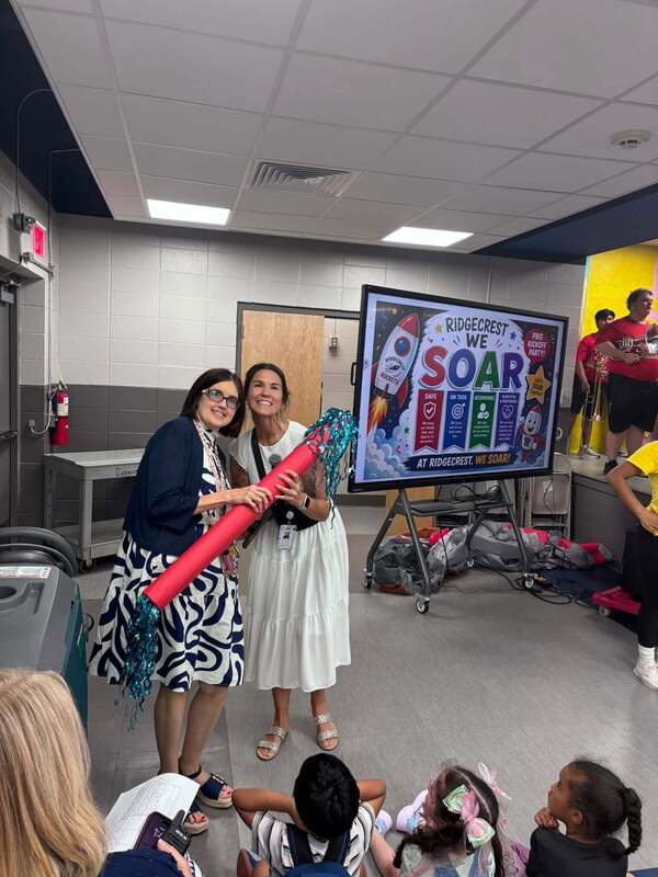 Mrs. Barksdale recieving the Spirit Stick from Ms. Brandon