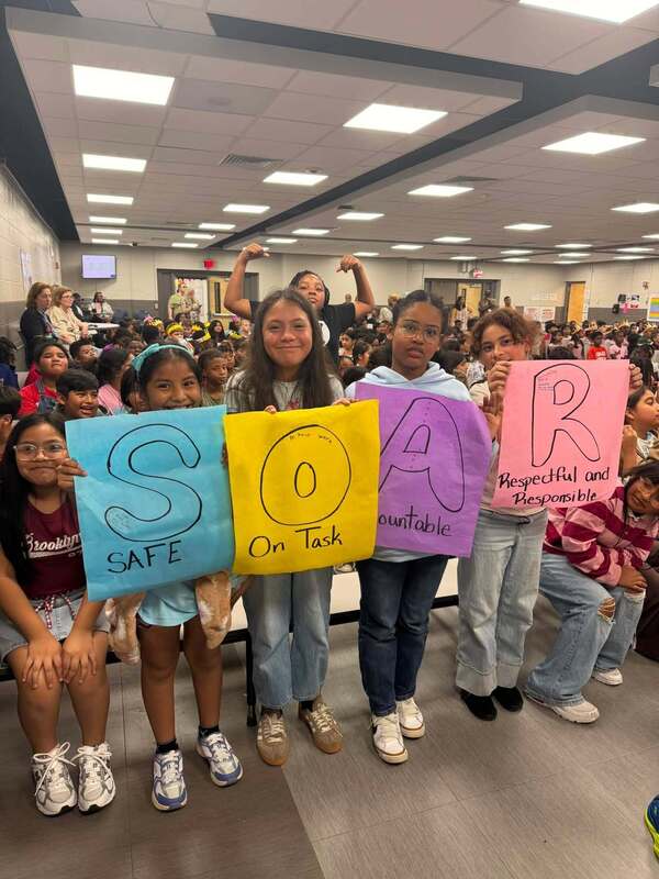 Fourth graders ready with signs at our assembly.