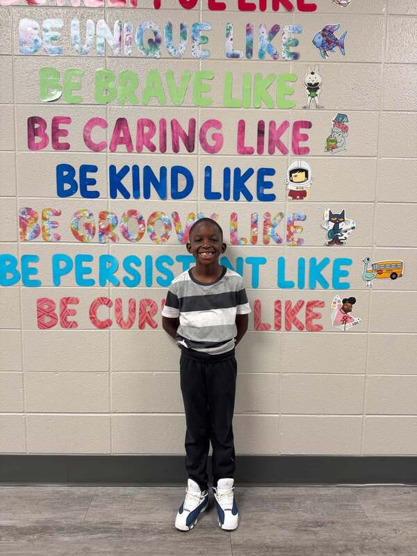 Our first grade student of the month with a huge smile on his face for being nominated