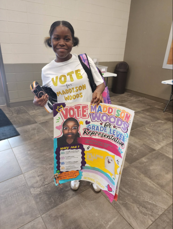 Maddison Woods displays her campaign poster.