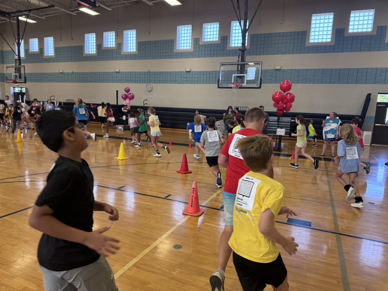 Ballons up while 75 3rd grade students running in the gym to show their support in earning their points for boosterthon