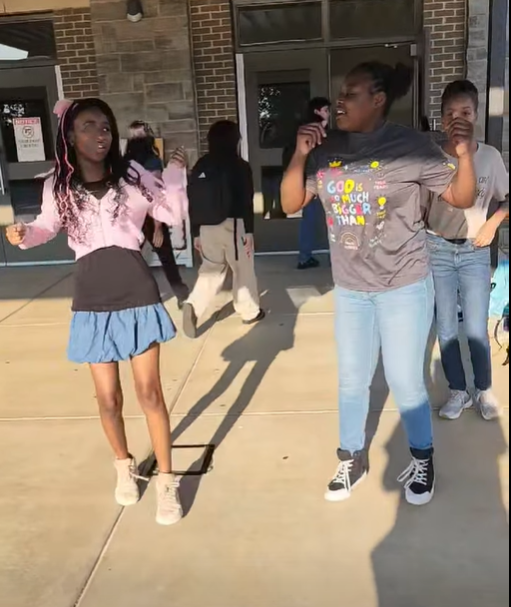Two girls dancing to Shakira