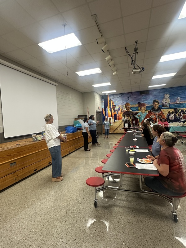 The Second Mile partners presenting in the cafeteria