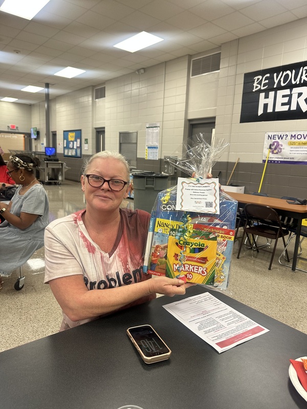 Ms. Angelia won the prize which included books, markers, and a connect 4 game.