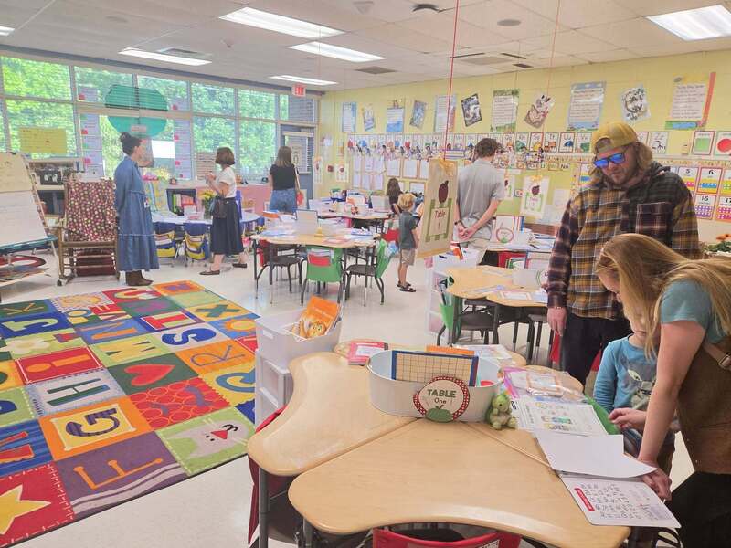 parents, students, and teaching standing in classroom