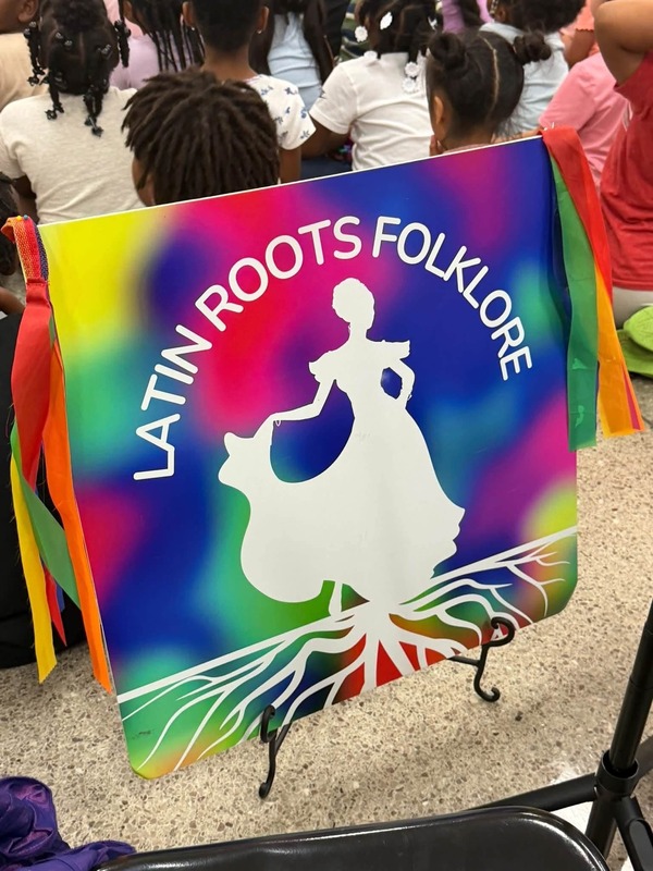 The Latin Roots' sign that says "Latin Roots Folklore."