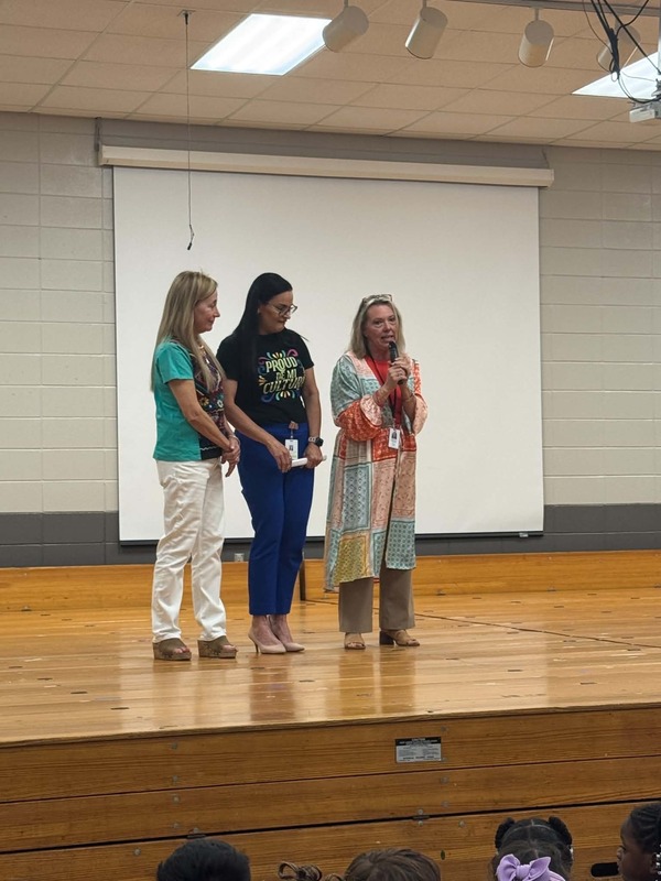 Ms. Hatcher, Ms. Ana Santos Diaz, and Ms. Sutton on stage closing out the program.