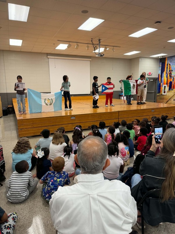 The fourth grade students on stage with their presentations.