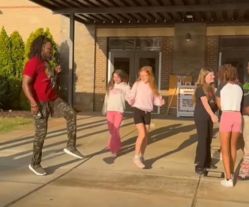 Mr. Palmer teaching students some new dance steps