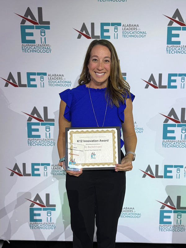 Rachel Evans holding her certificate at ALET