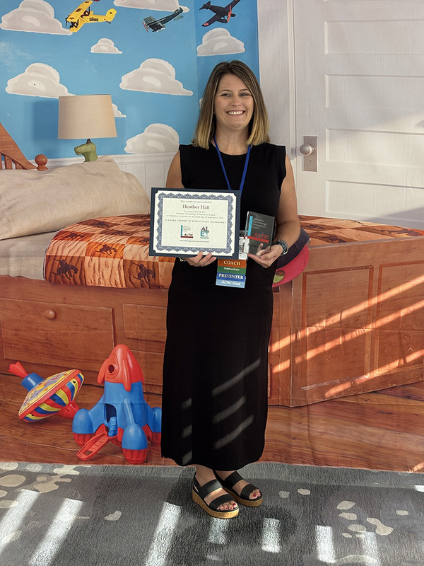 Heather Hall holding her certificate at ALET