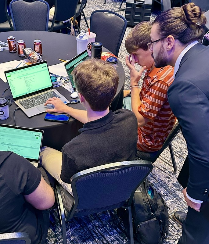 Students work on a laptop at the Cyber Summit.