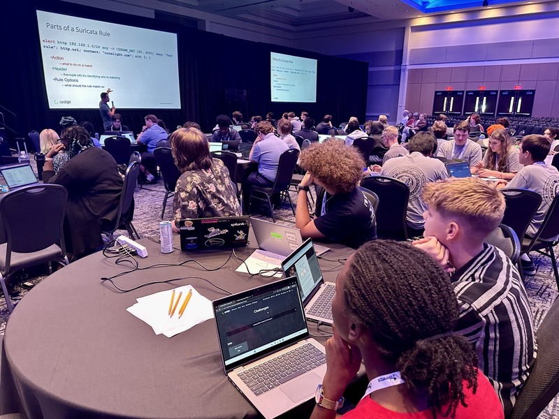 Students view a presentation at the Cyber Summit.