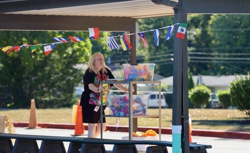 Mrs. Gatzke pushing a cart with decorations for the celebration.
