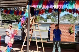 Teachers helping put up decorations before the event.