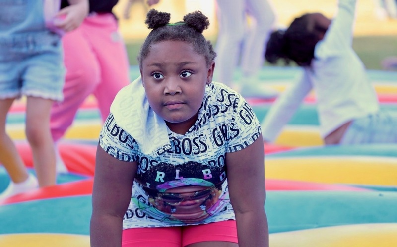 A second grader playing on the bounce pad.