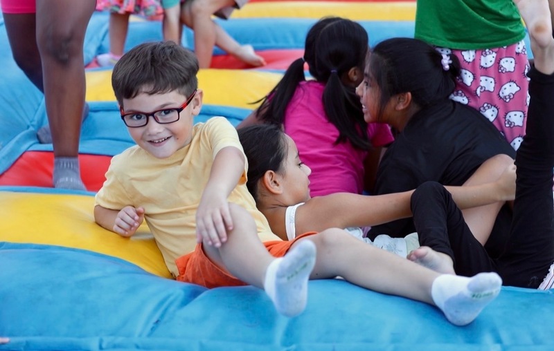 Students enjoying the bounce pad during the celebration.