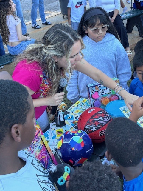Ms. Aguilar checking winners cards.
