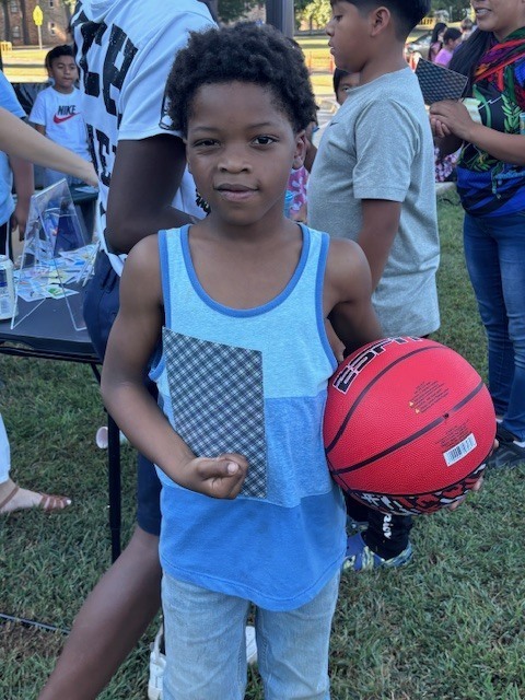 Student with his basketball prize from Loteria.