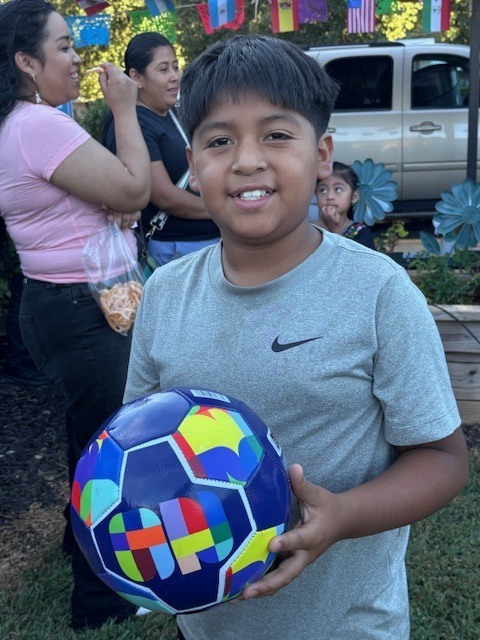 Loteria winner and his soccer ball prize.