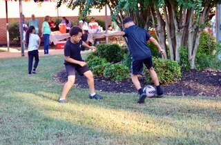 Students playing soccer during the party.